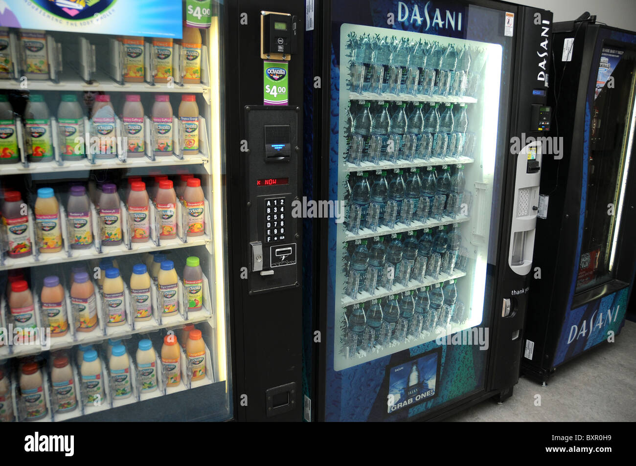 A vending machine filled with bottled water and juice. Stock Photo