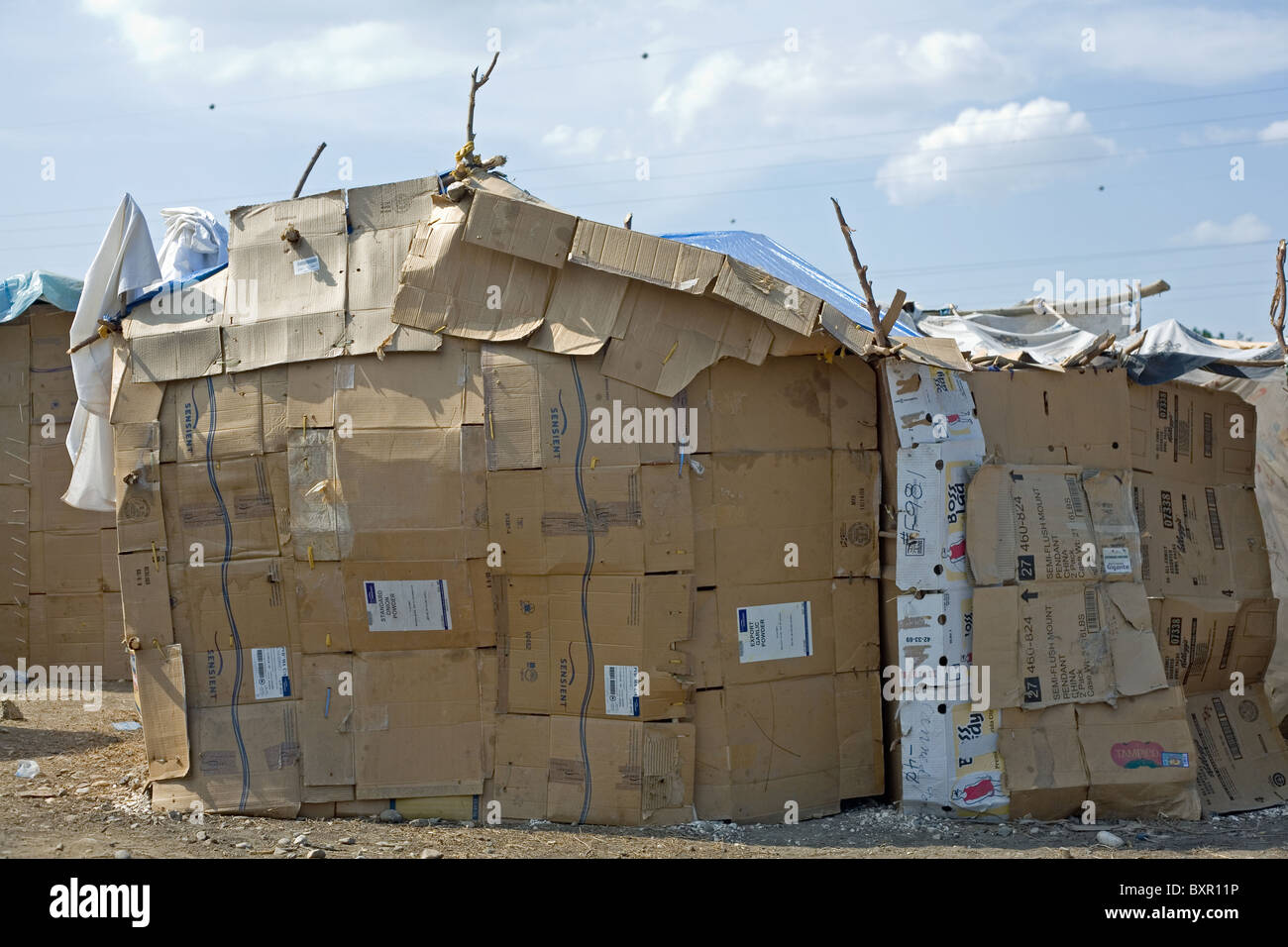 A temporary shelter clad in cardboard boxes and plastic sheeting at a camp close to Port-au-Prince airport Stock Photo