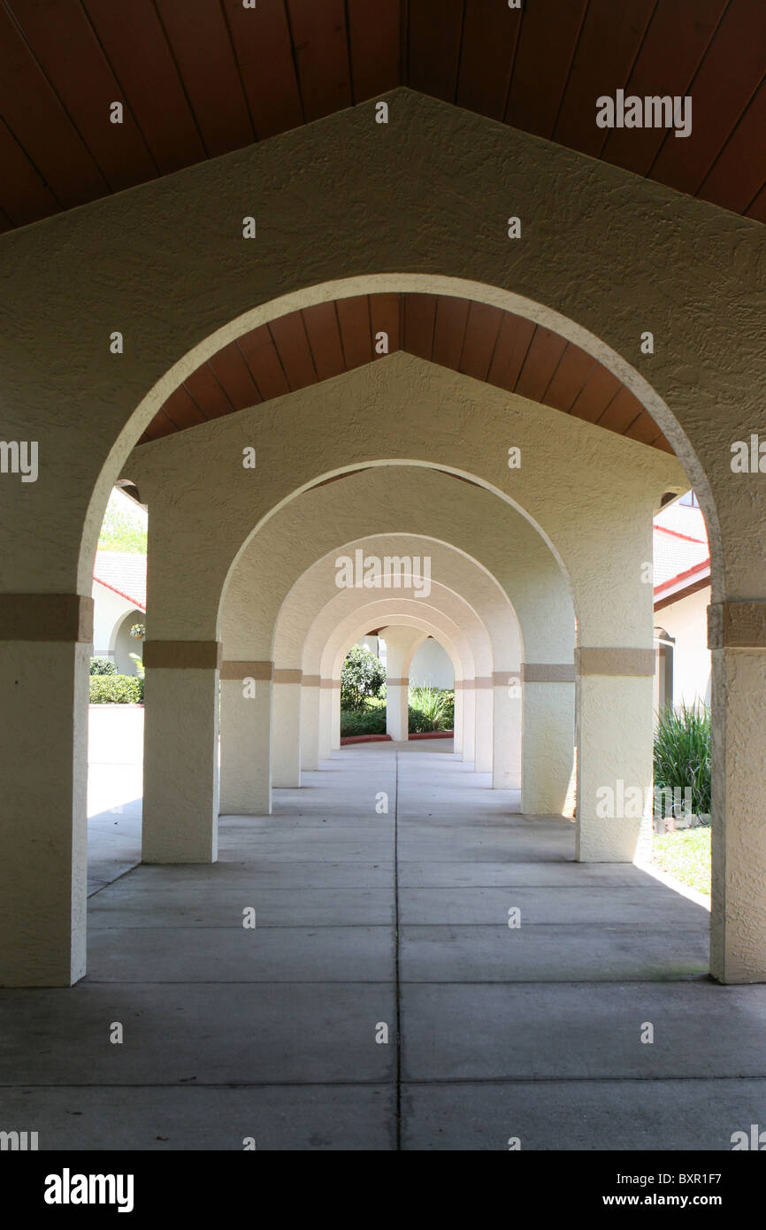 Arches that support a walkway give a prospective of depth as they line the corridor. Stock Photo