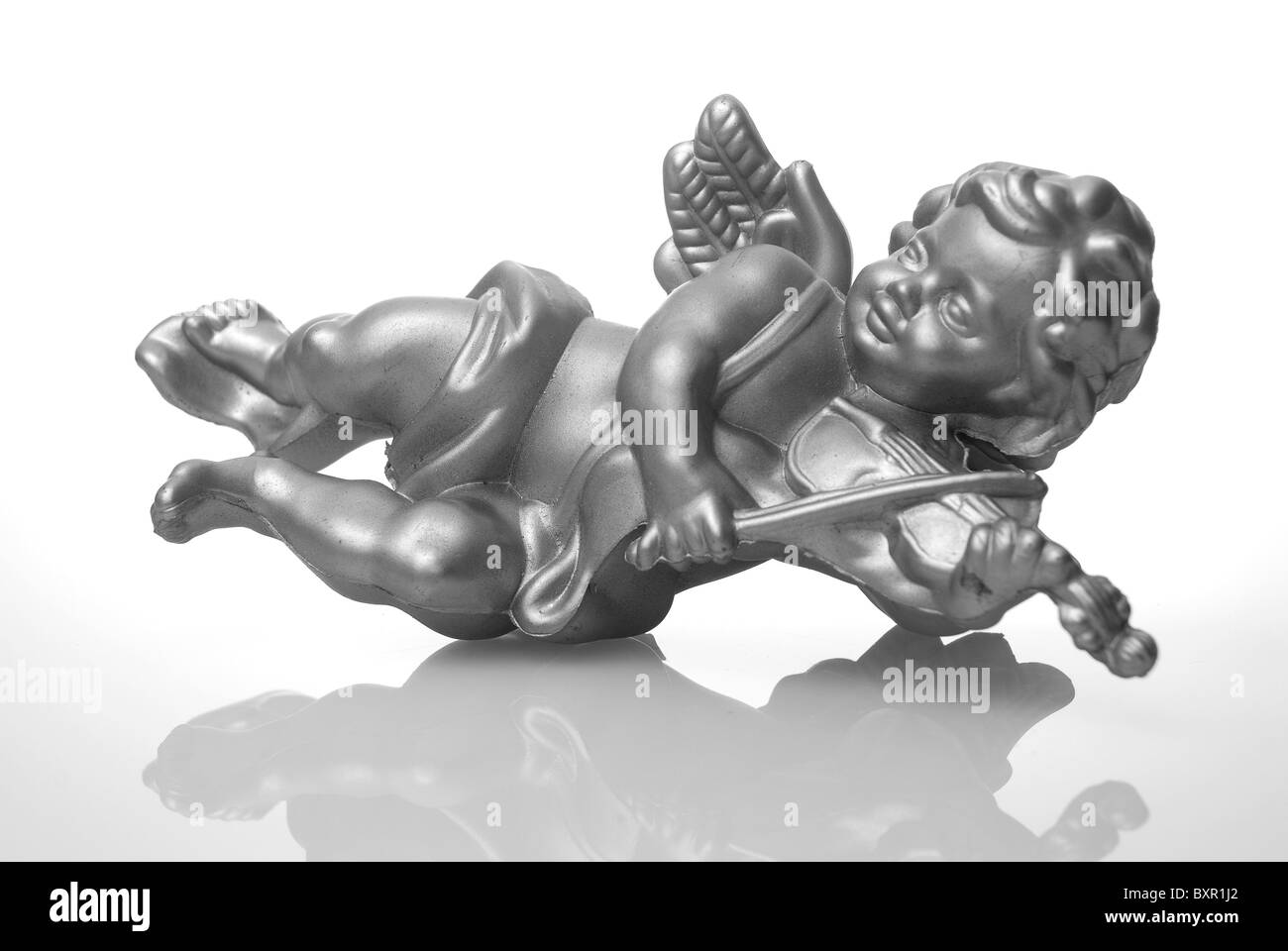 Angel plastic statue of an silver angel playing violin with reflection
