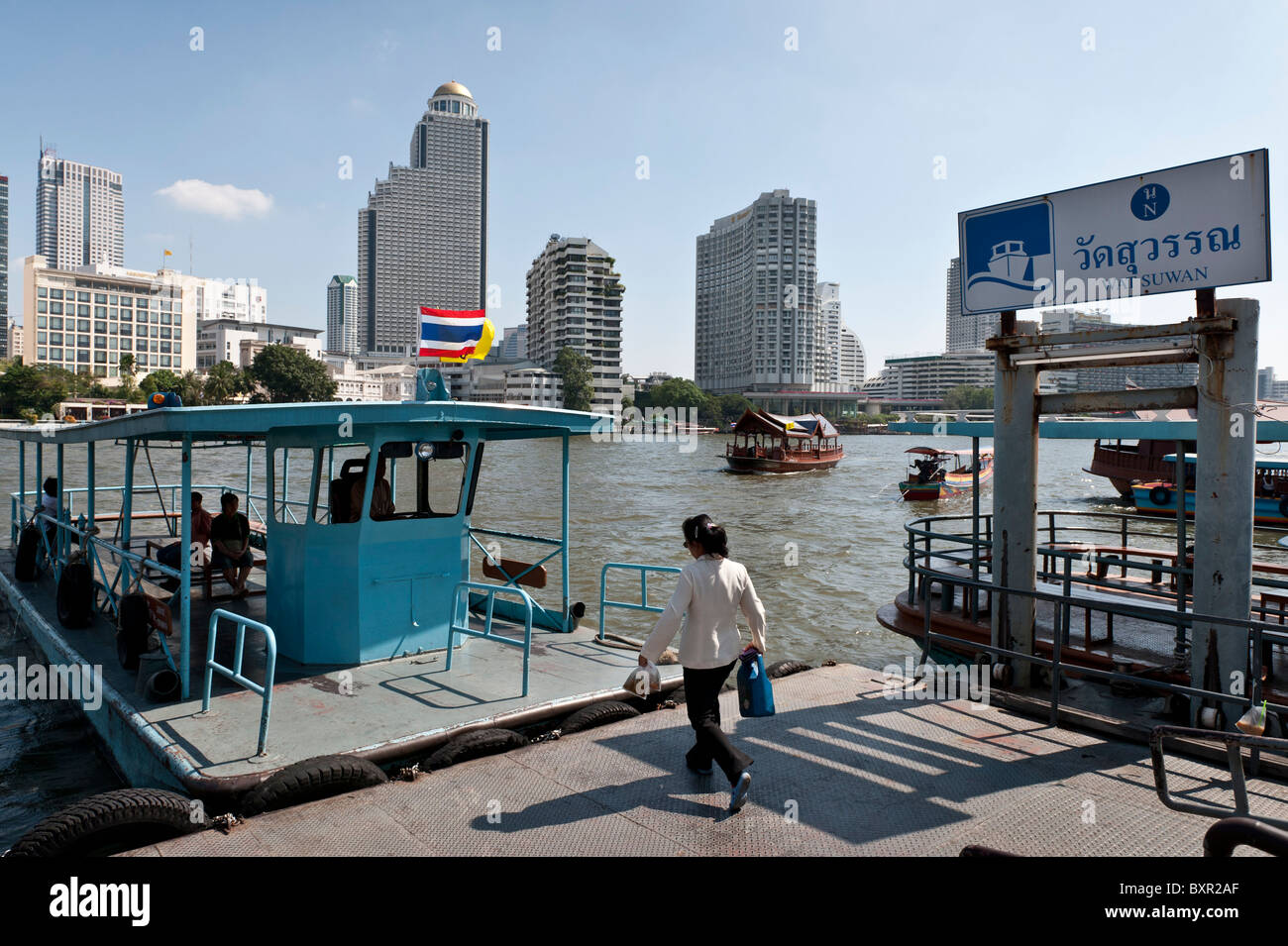 The Chao Phraya river is the royal river cutting through Bangkok and full of different types of boats and other river transport. Stock Photo