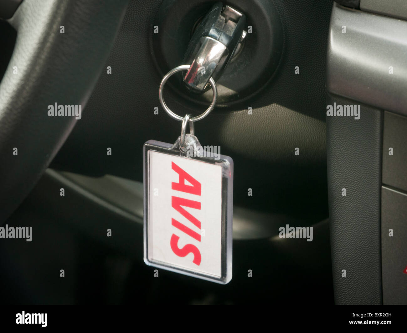 A key in the ignition of an Avis hire car Stock Photo Alamy