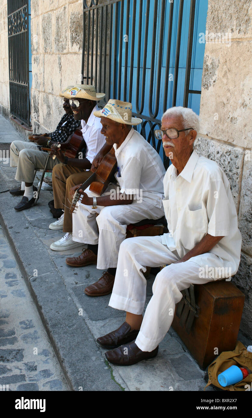 Los Cambasinos street band, playing outside a big blue door in  Plaza de la Catedral, Havana, Cuba. Stock Photo
