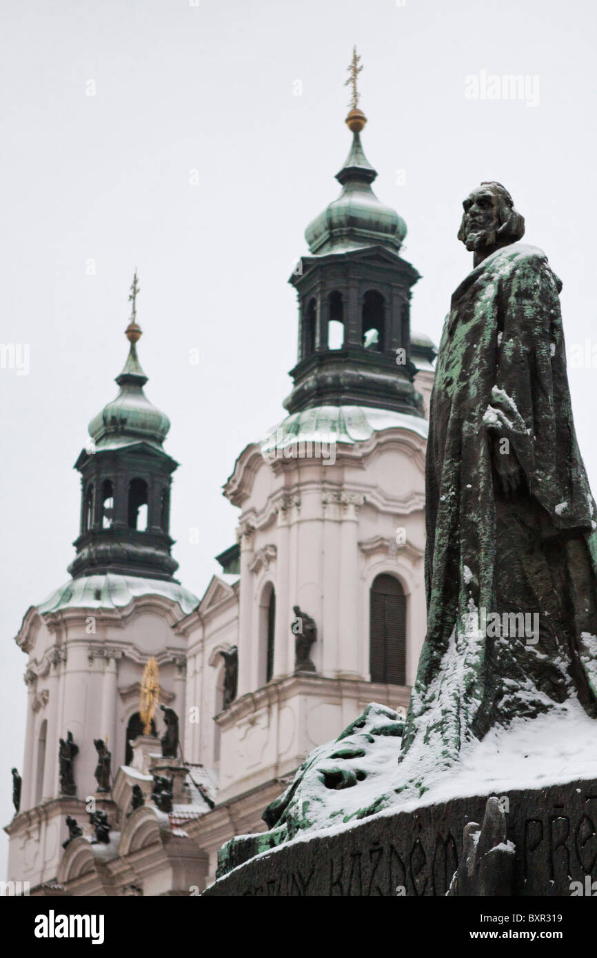 Statue of Jan Hus, Old Town Square, Prague with St. Nicholas Church in the background Stock Photo