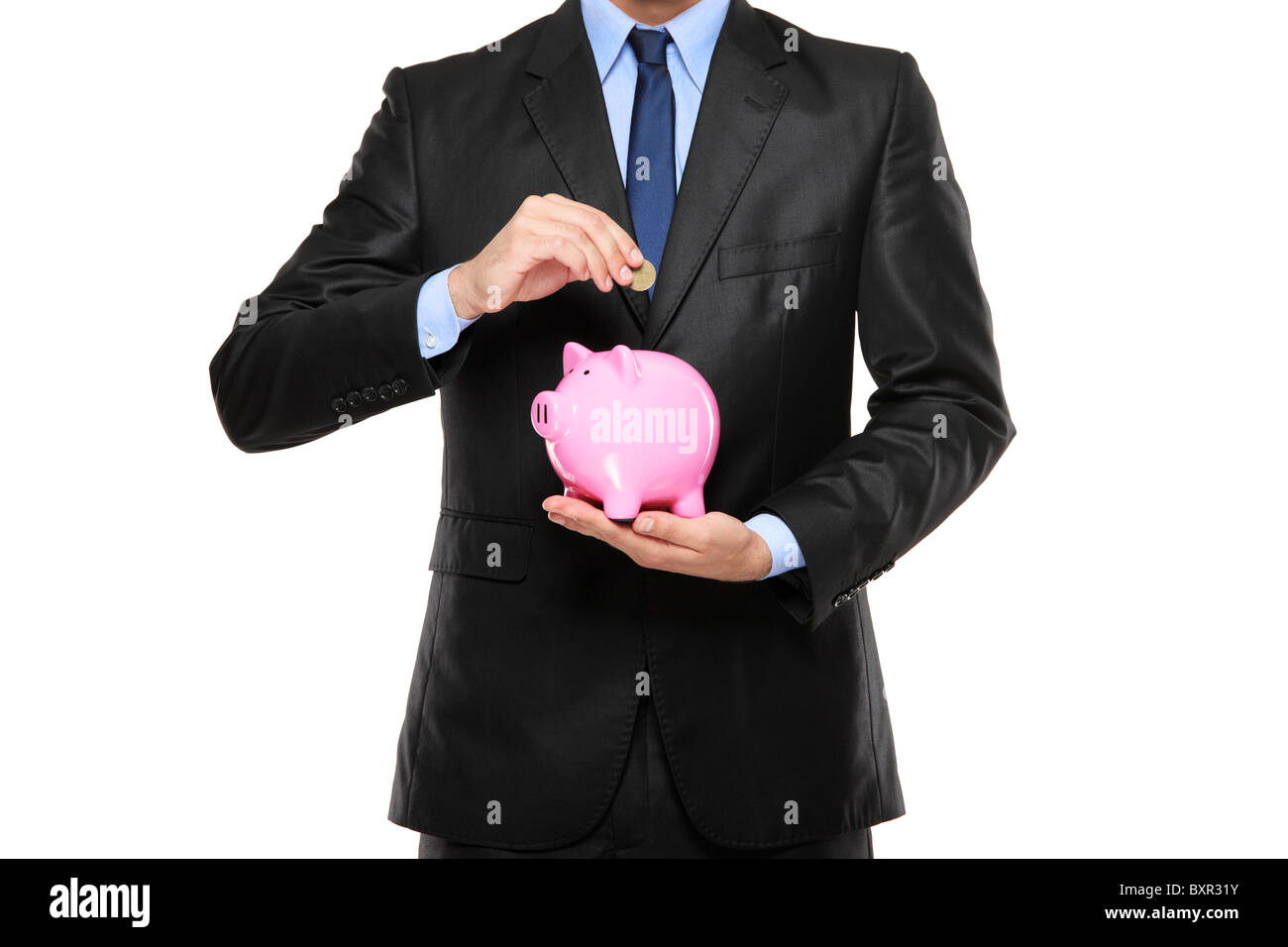 Putting a coin into a piggy bank Stock Photo - Alamy