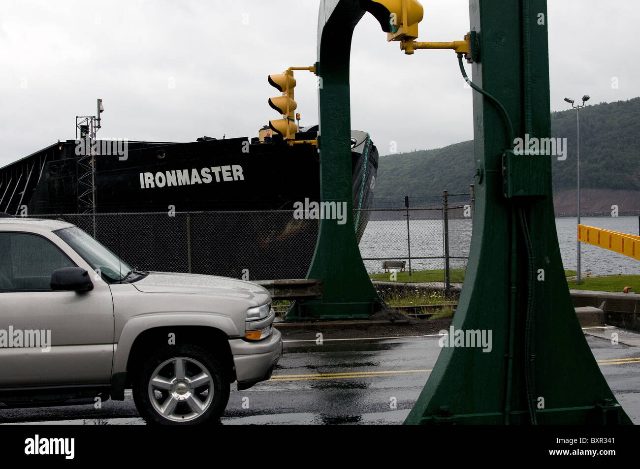 Car waiting for bulk carrier ship to go through lock in Nova Scotia Stock Photo