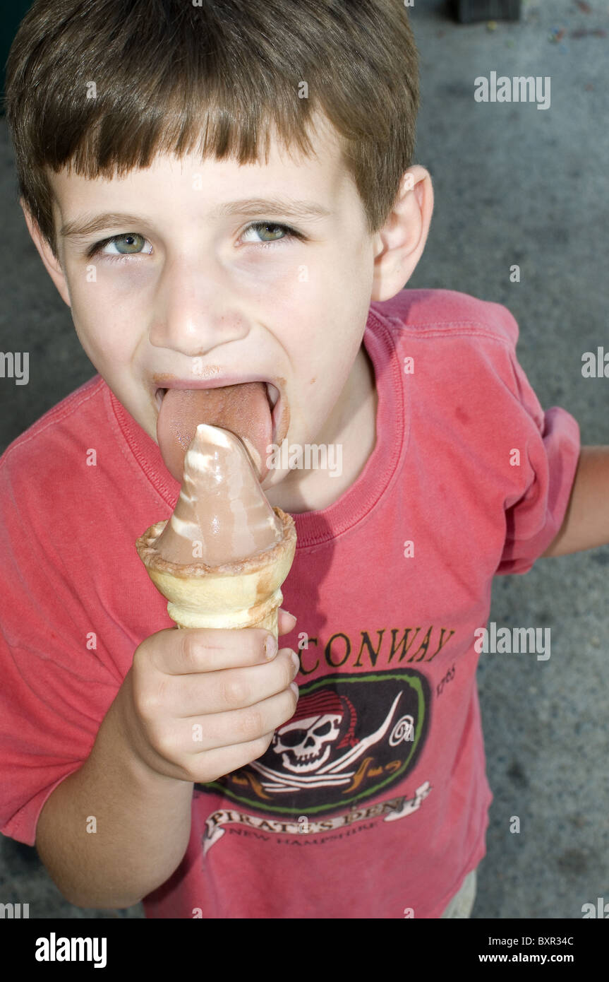 young boy eating ice cream cone mouth open child Stock Photo Alamy
