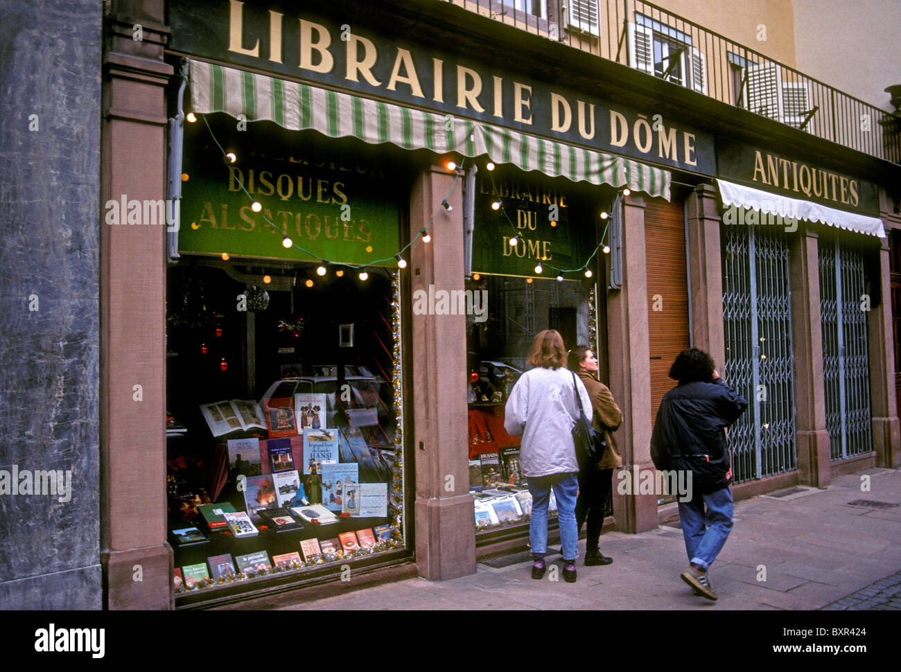 French people person young women females window shopping at bookstore Librairie du Dome city of Strasbourg Alsace France Europe Stock Photo