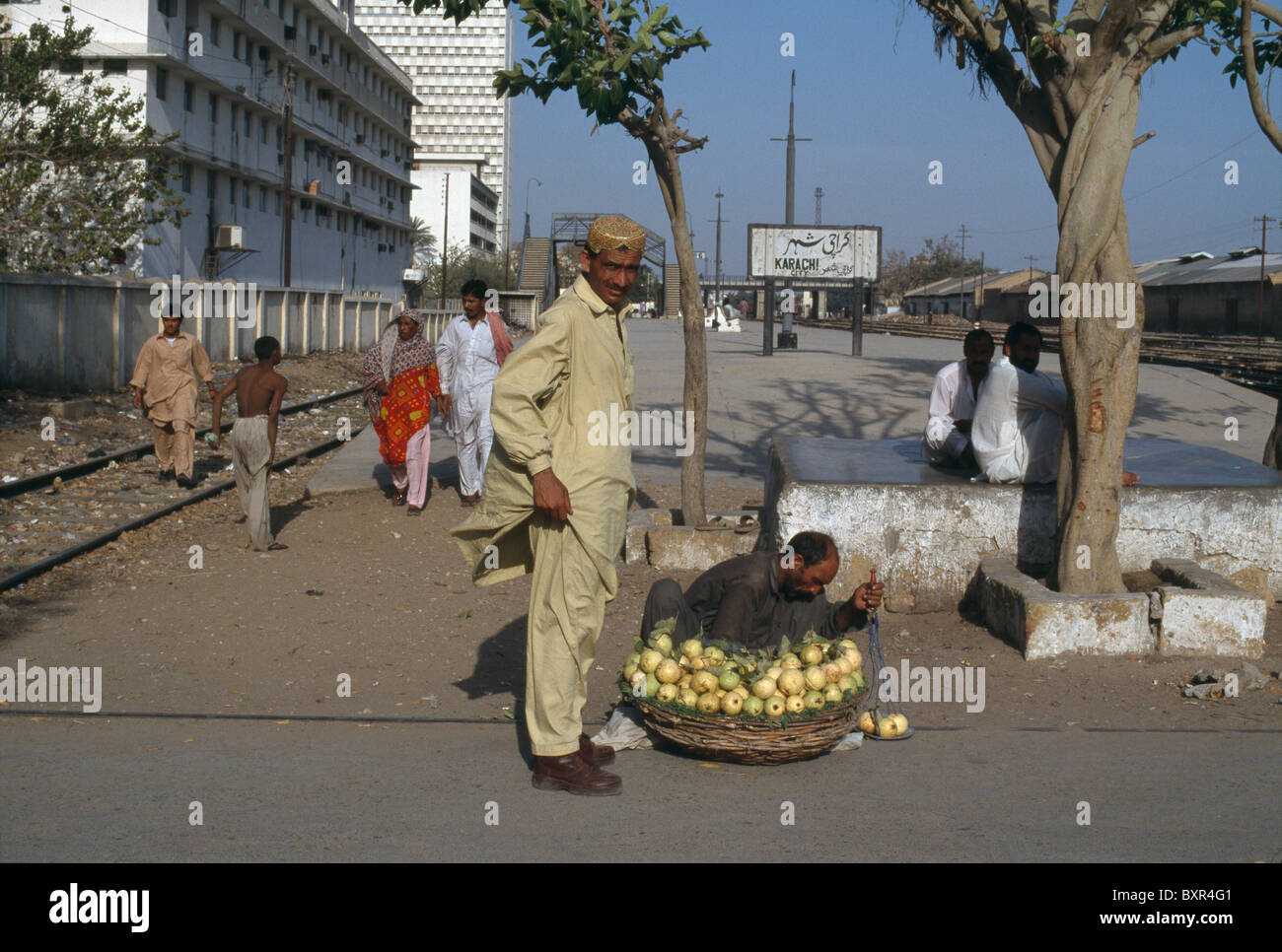 A Pakistani man buys fruit at a Karachi, Pakistan railroad station. Stock Photo