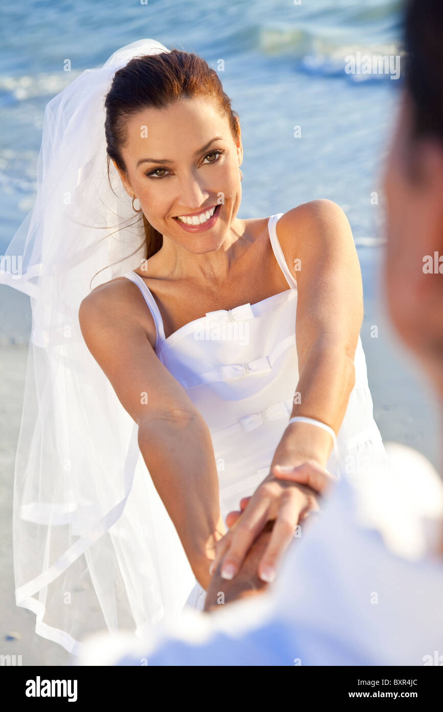 a-married-couple-bride-and-groom-together-holding-hands-laughing-and