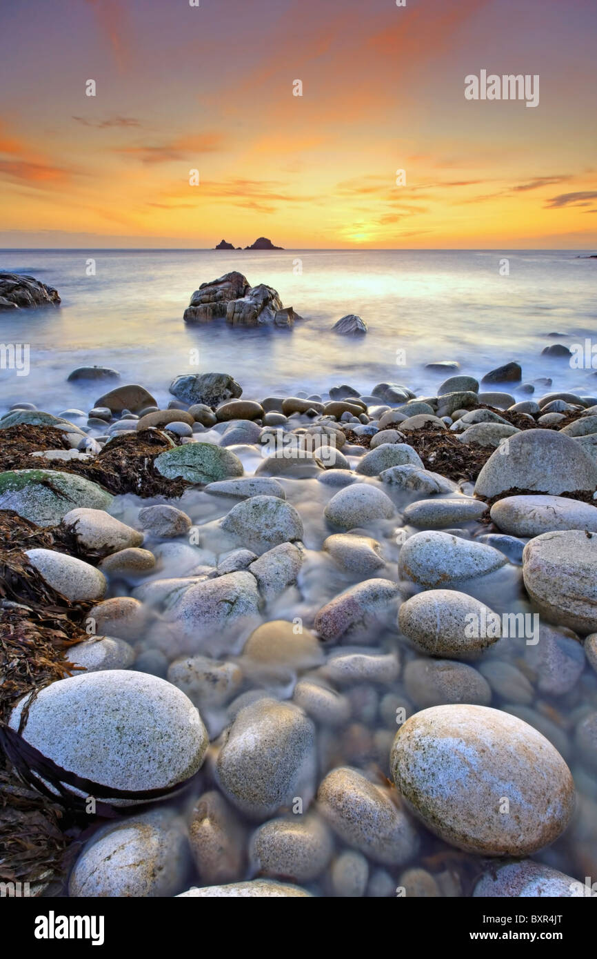 Boulders Strewn stream at Porth Nanven Cove in West Cornwall Stock Photo