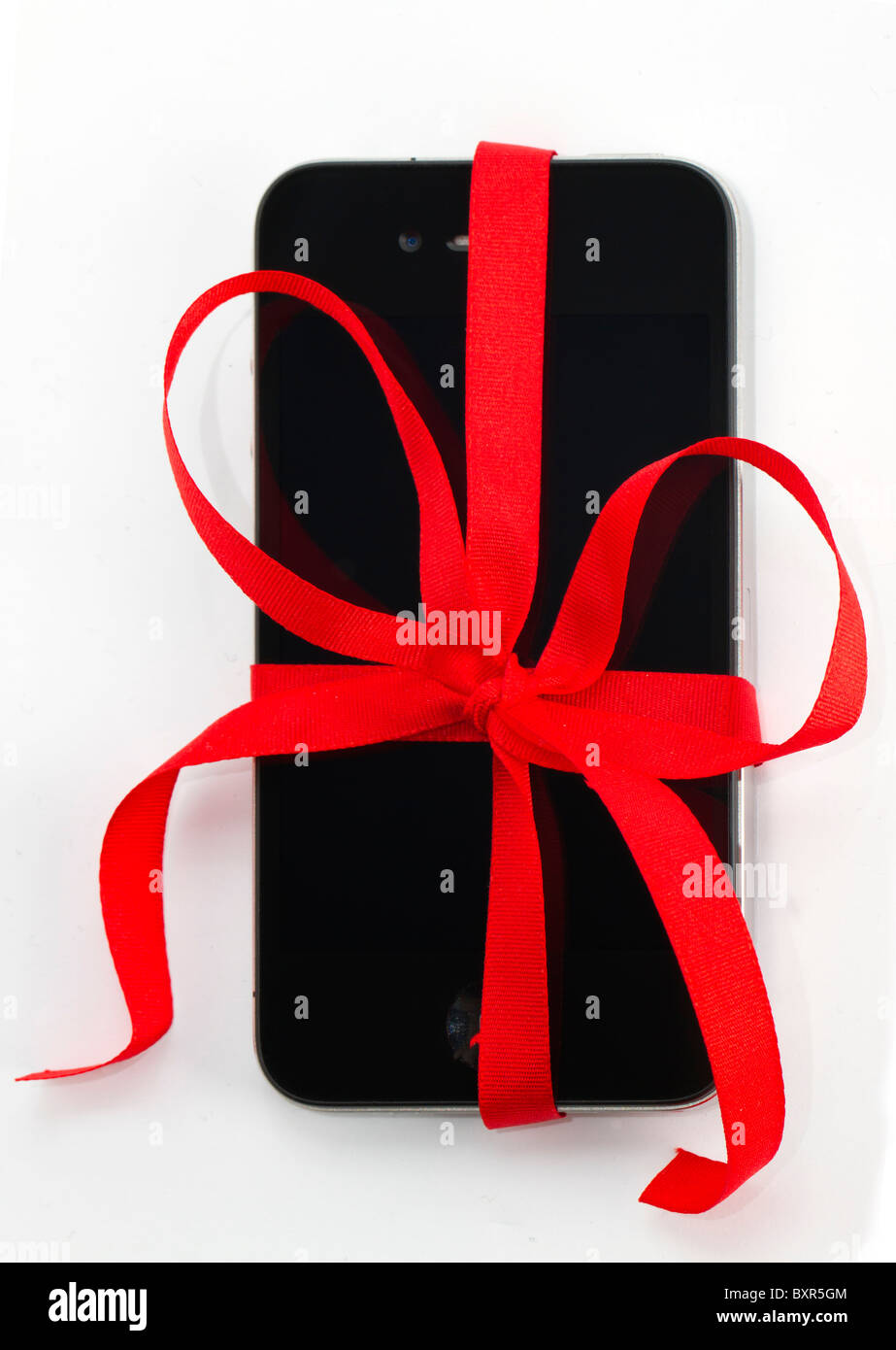 Apple iPhone 4 with a red gift bow. Stock Photo