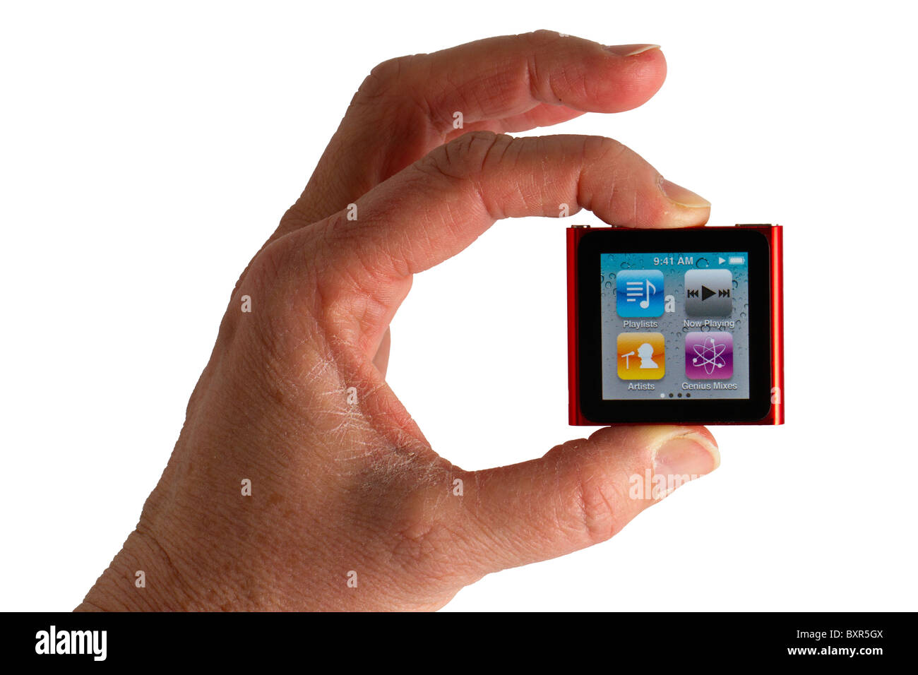 Apple iPod Nano, sixth generation, held by a hand, on white background. Stock Photo
