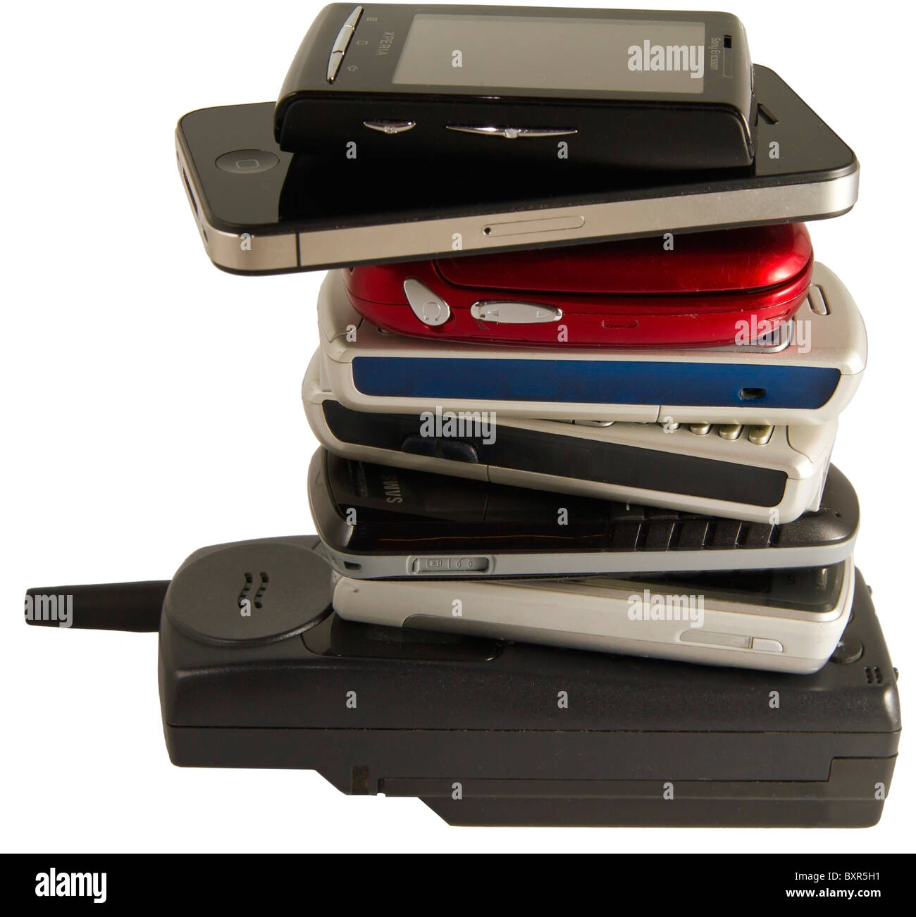 Pile of old and new mobile phones on white background. Phone on top is the Sony Ericsson Xperia X10 mini. Second one is iPhone 4 Stock Photo