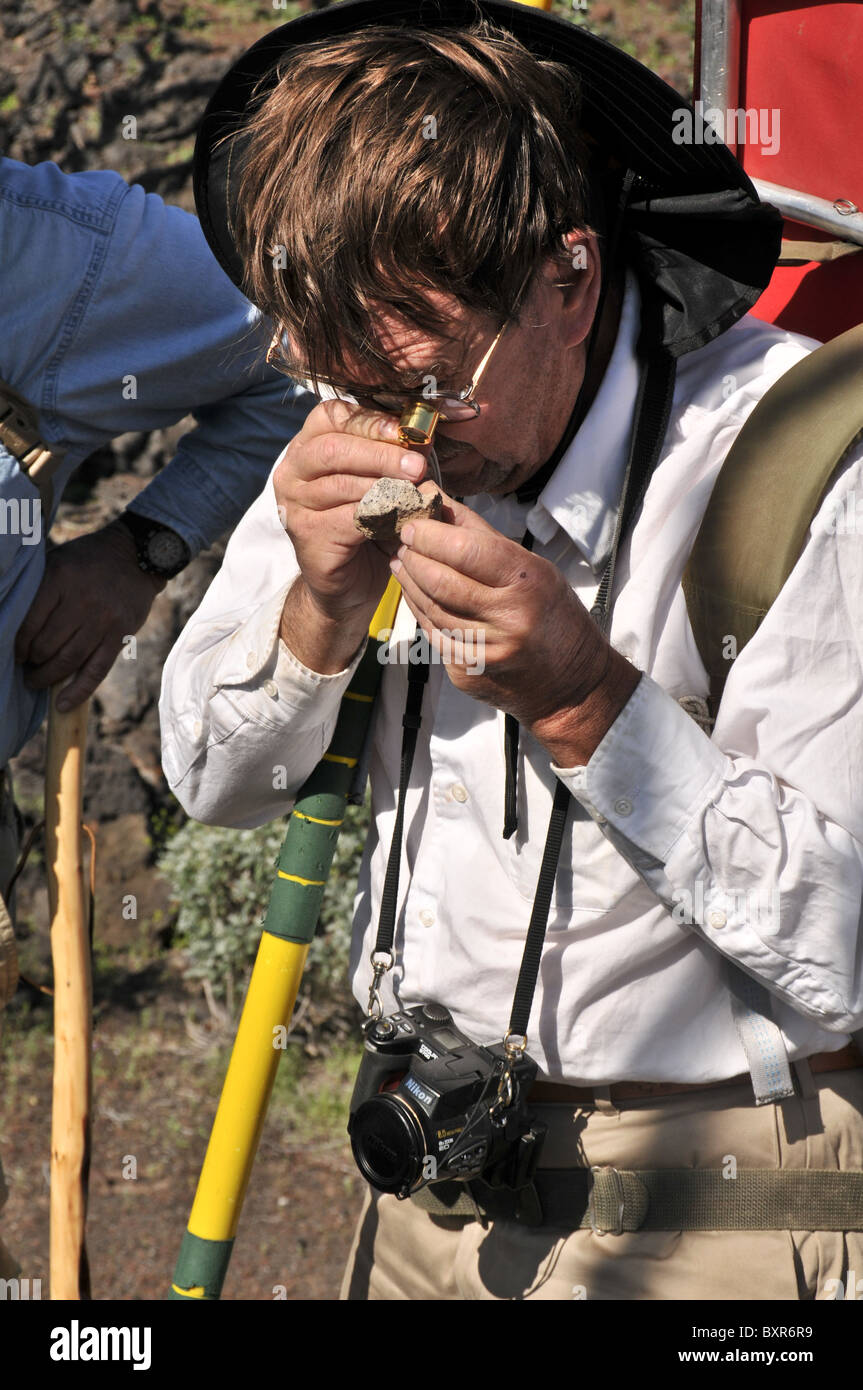 Geologist viewing rock with hand lens, El Pinacate Biosphere Reserve, Sonora, Mexico Stock Photo