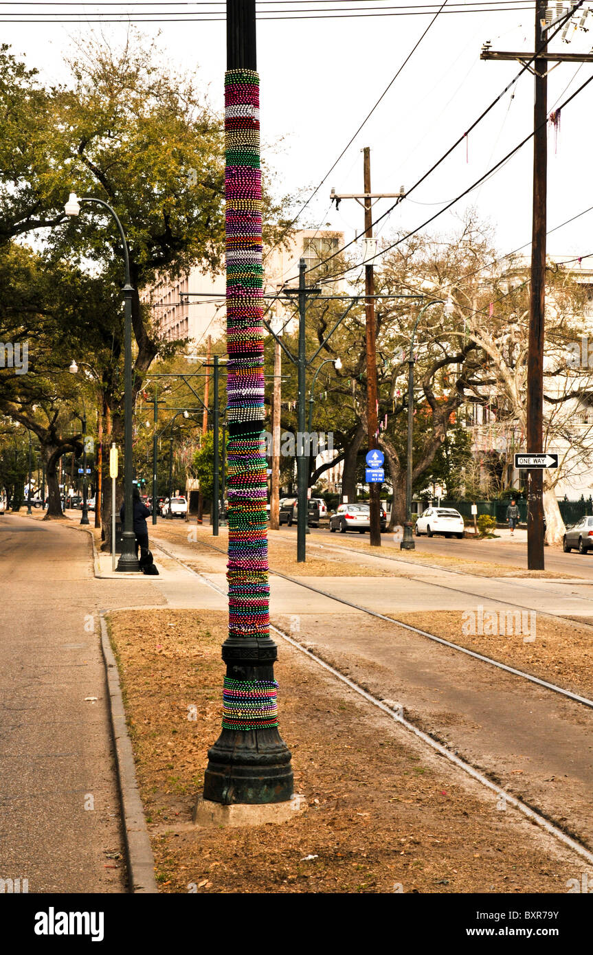 Light pole decorated with Mardi Gras beads, St. Charles St. parade route, New Orleans, Louisiana Stock Photo