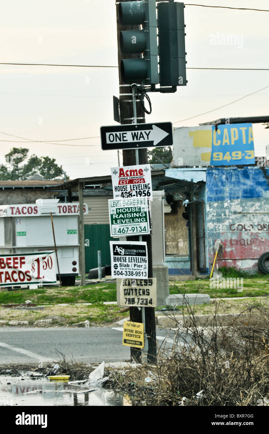 Street corner signs offering construction services in Lower 9th Ward after Hurricane Katrina flood, New Orleans, Louisiana Stock Photo
