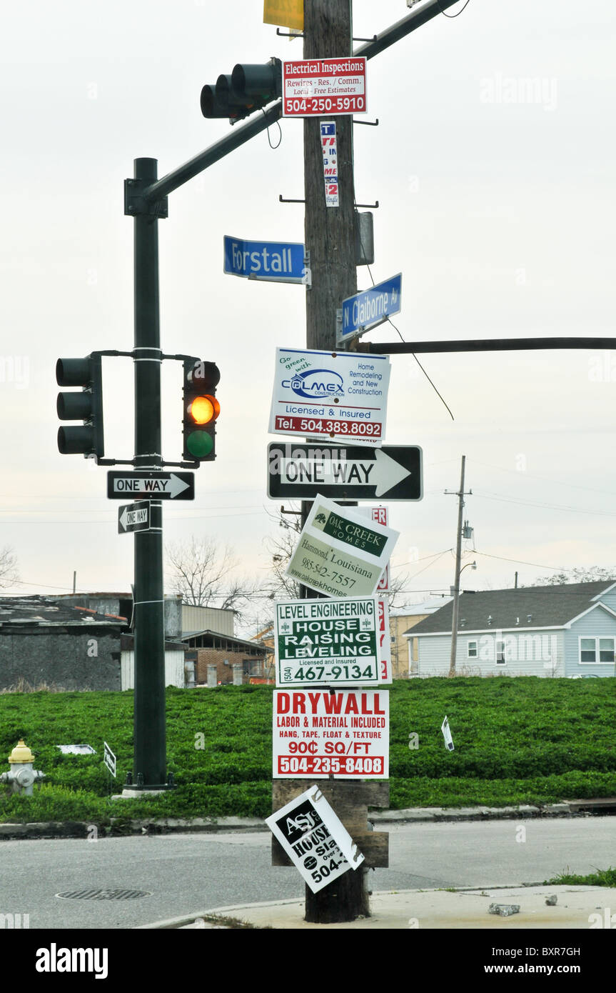 Street corner signs offering construction services in Lower 9th Ward after Hurricane Katrina flood, New Orleans, Louisiana Stock Photo