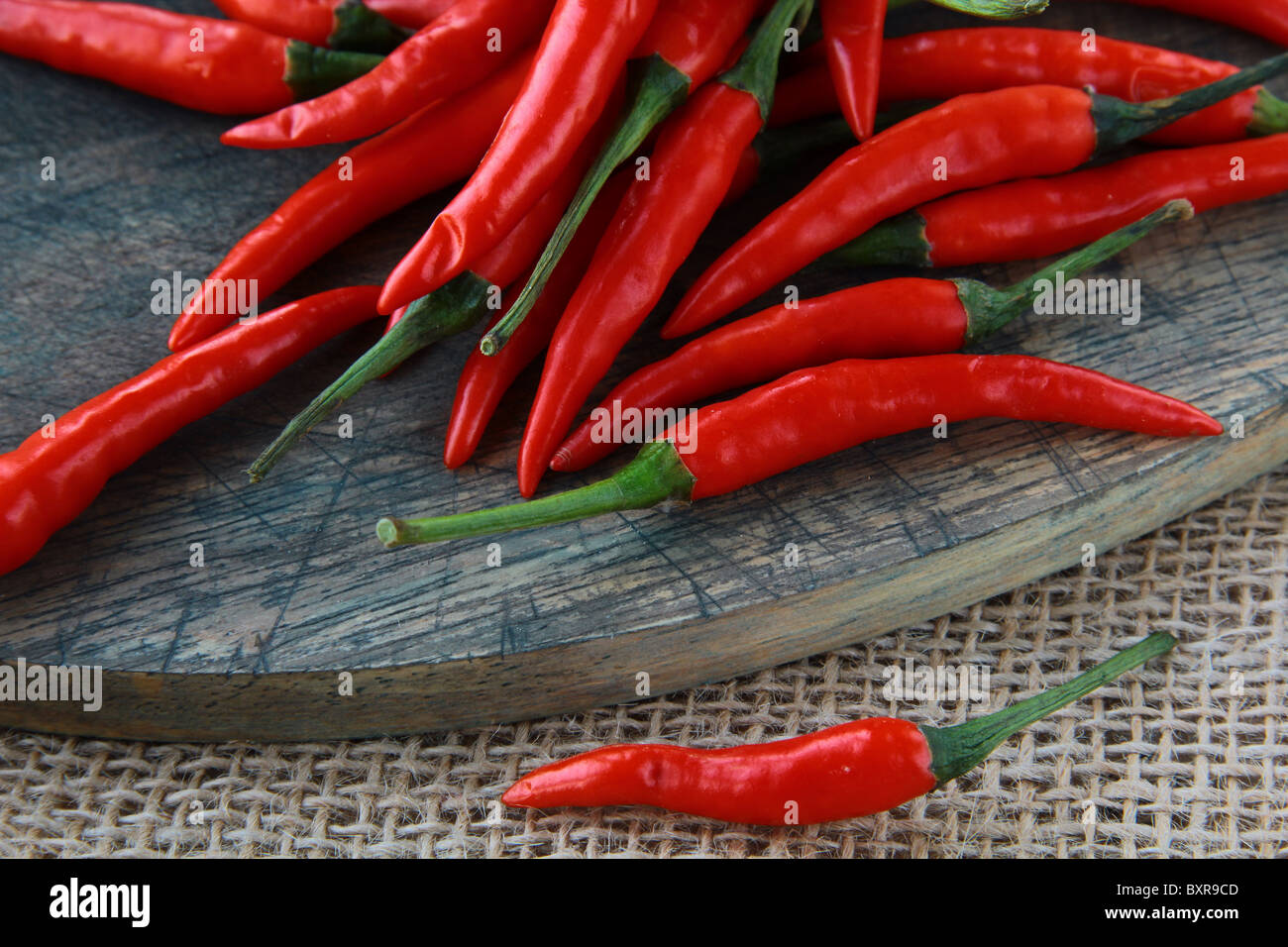 Red hot chili peppers over wooden background Stock Photo - Alamy