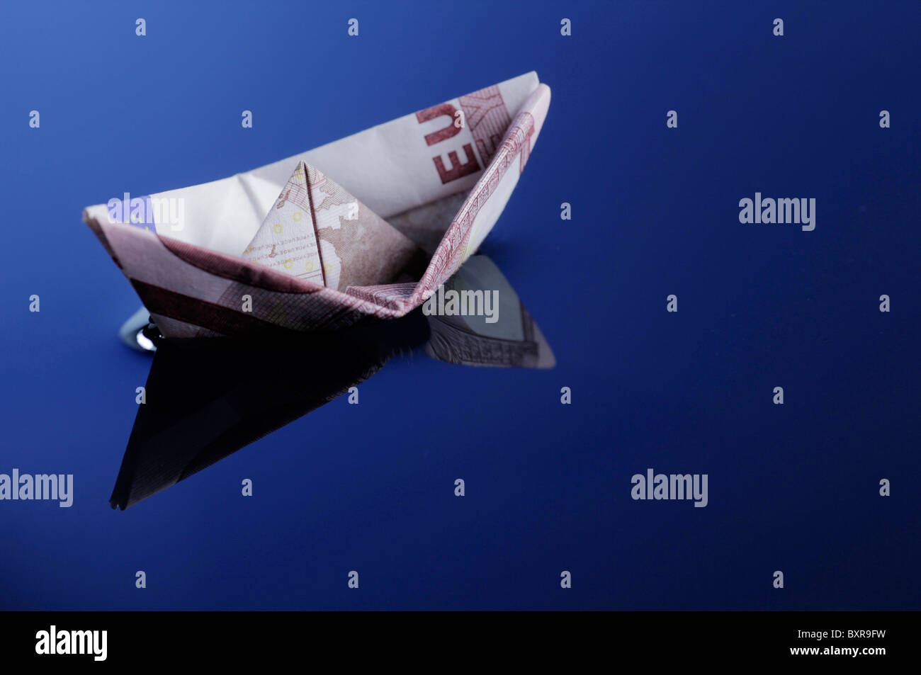 Boat made from 10 Euro note floating Stock Photo