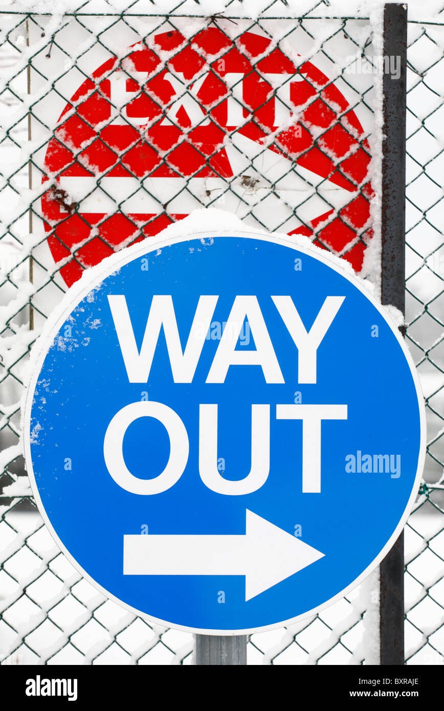 Way Out and Exit signs in the snow. Stock Photo