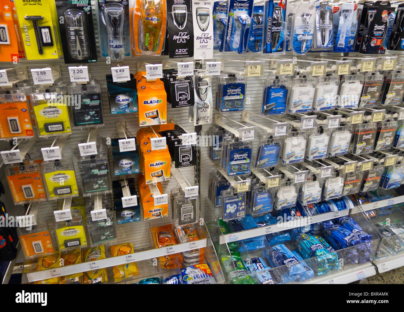 Razors and razor blades for sale in a chemist shop. Stock Photo