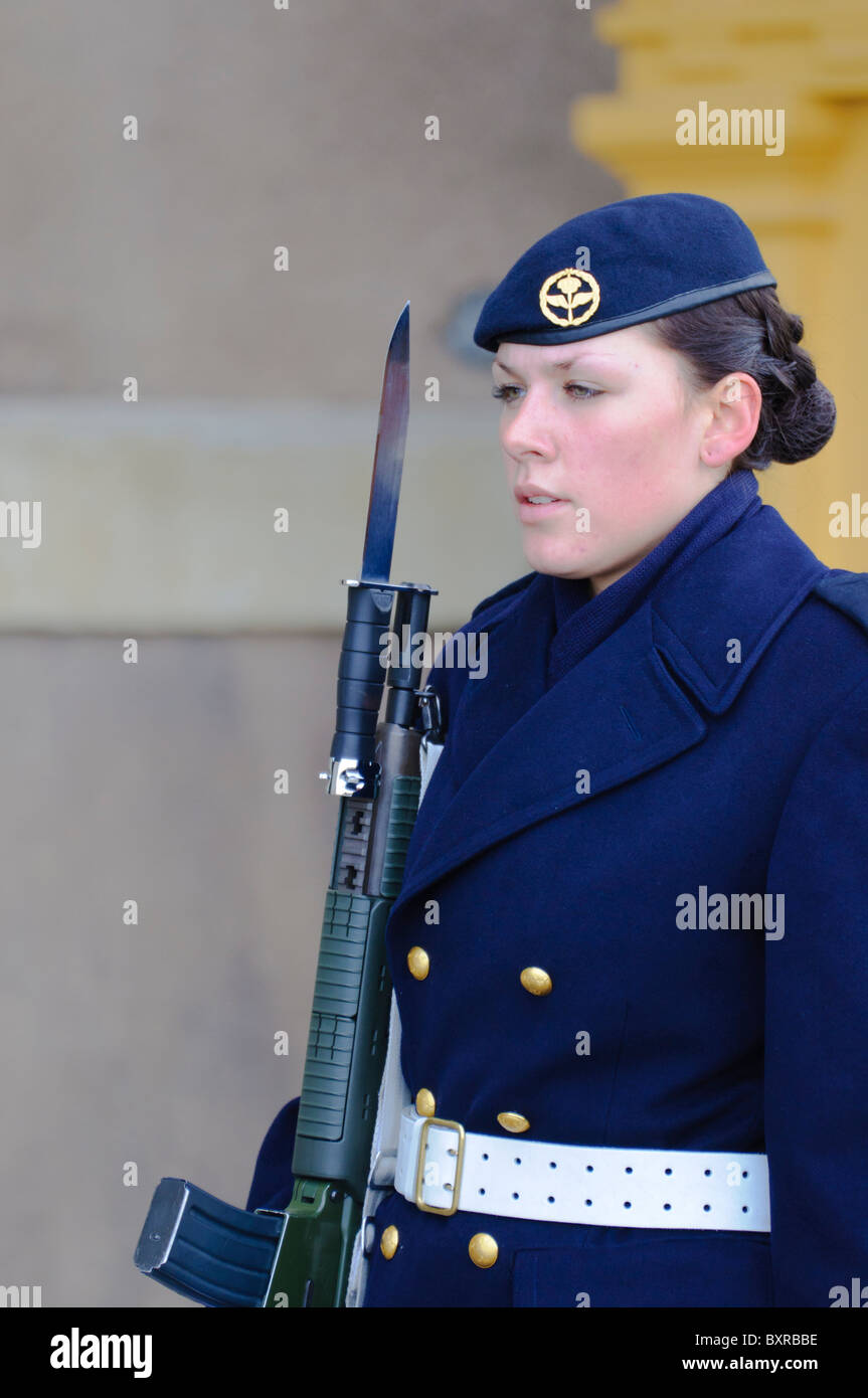 Female soldier on guard duty outside the Royal Palace (Kungliga Slottet) in Stockholm, holding a rifle fitted with a bayonet Stock Photo