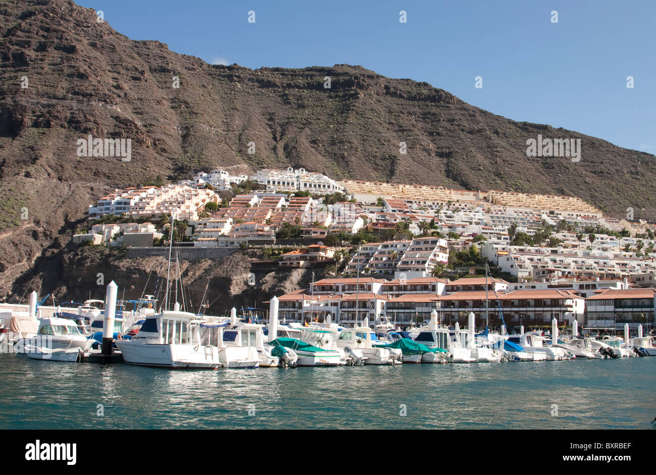 Los Gigantes with the marina in the foreground and Acantilados de Los Gigantes in the background, Tenerife, Canary Islands Stock Photo