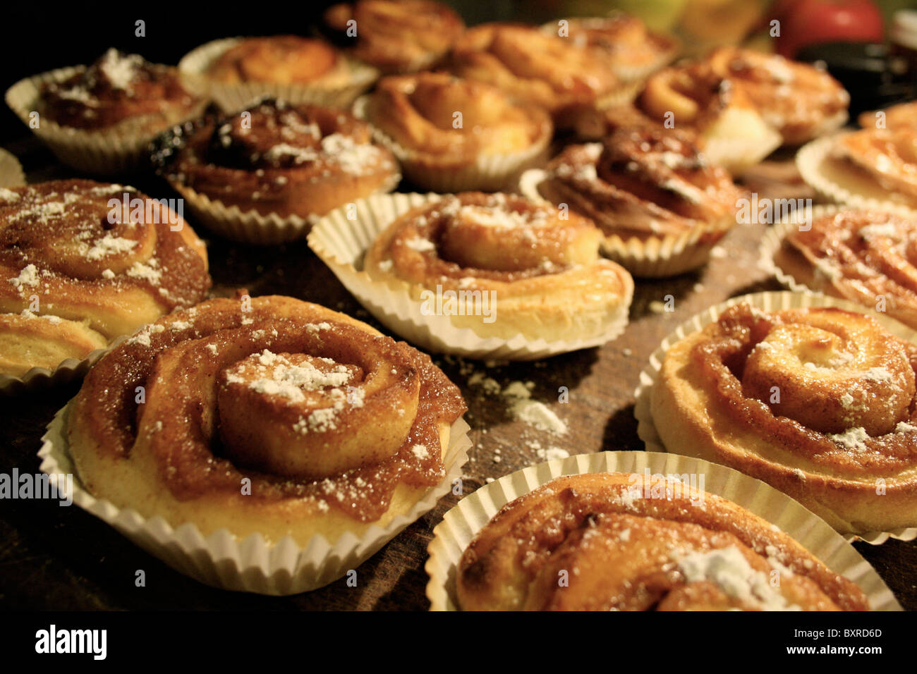 Swedish cinnamon buns on a cheeseboard. Stock Photo