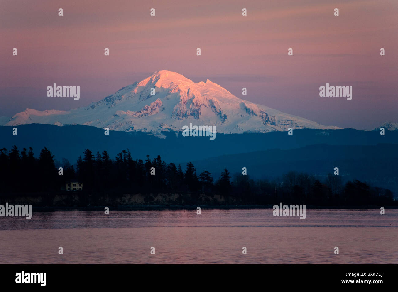 Mt. Baker, in Washington State, is awash in alpenglow after a spectacular sunset in the San Juan Islands. Stock Photo