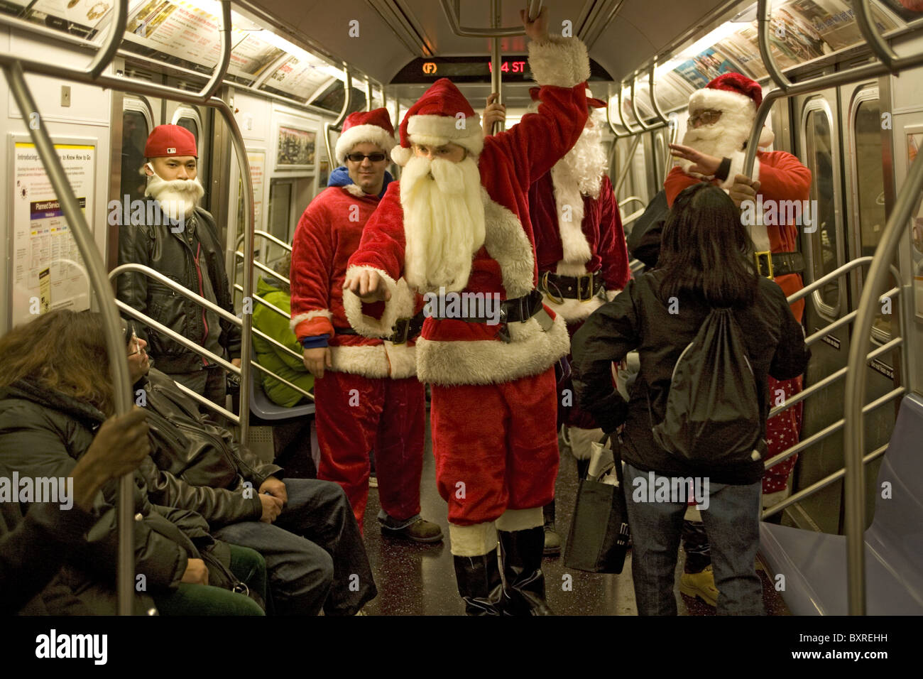 Santas on the subway in New York City during the holiday season Stock