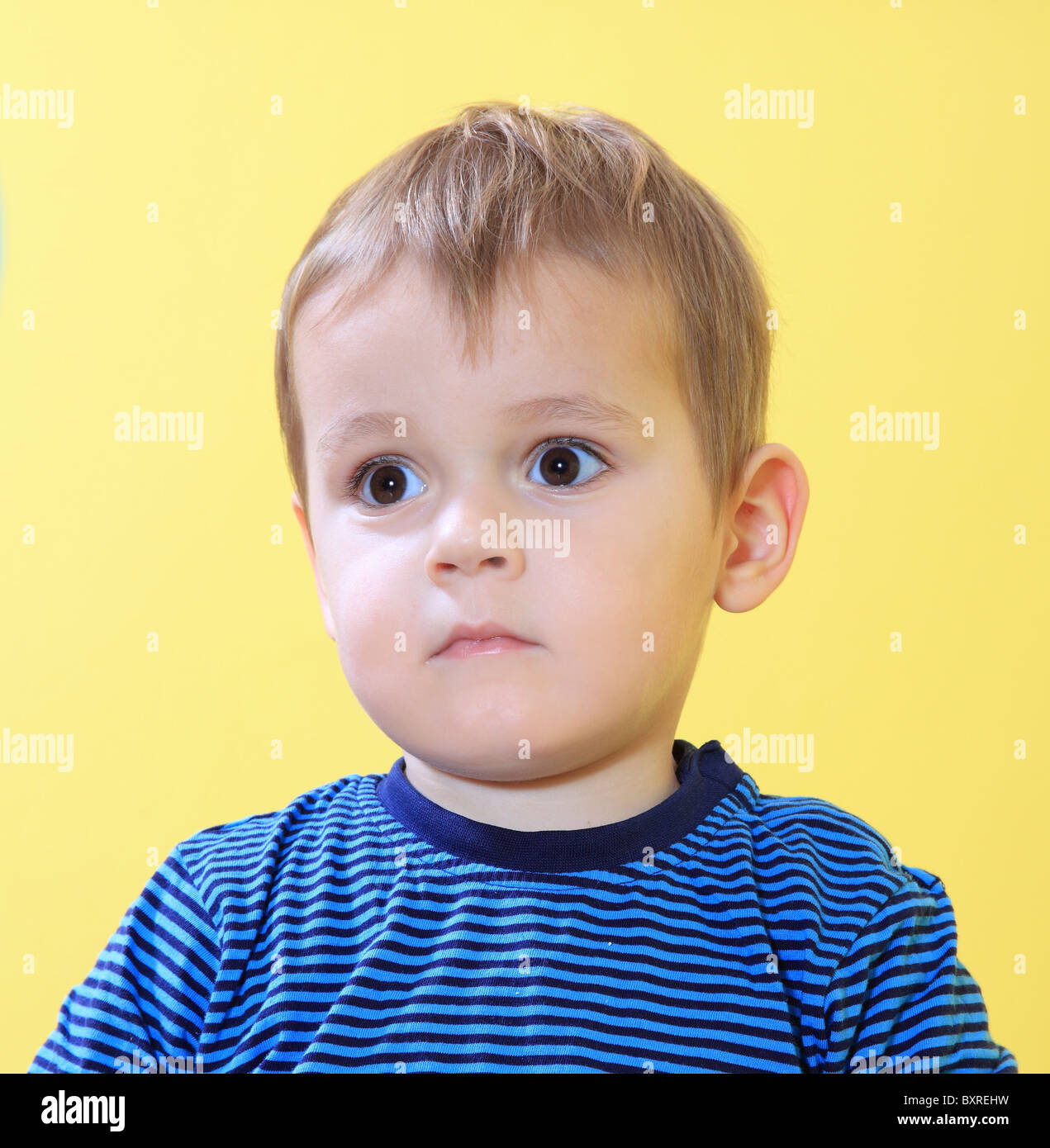 Sad little toddler missing his mum in kindergarten. Stock Photo