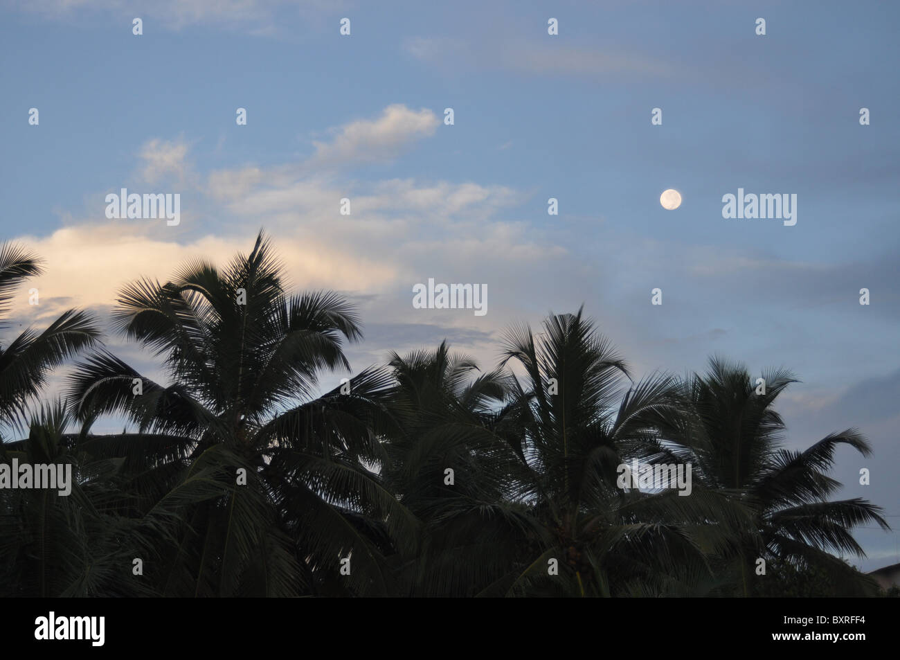 Sunrise over Mangalore can not dim the moon Stock Photo