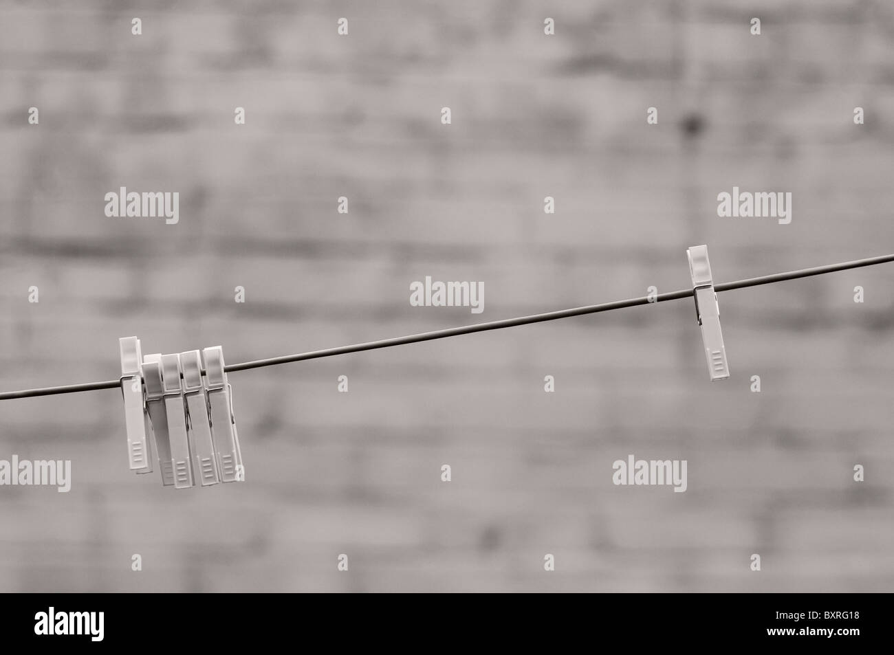 Plastic clothes pegs on washing line. Stock Photo