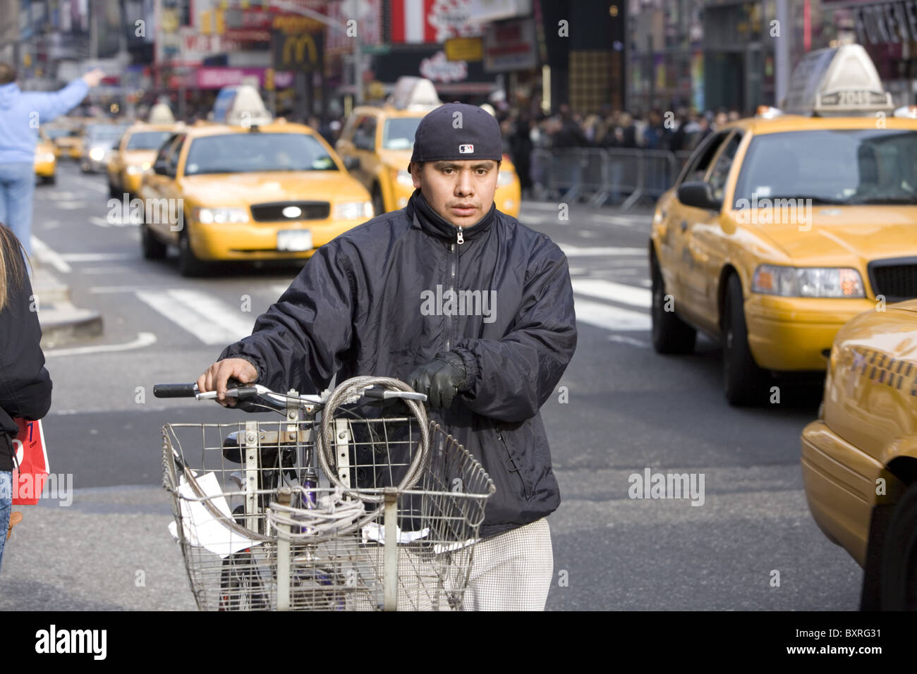 Young Hispanic delivery boy on Broadway in NYC. Stock Photo