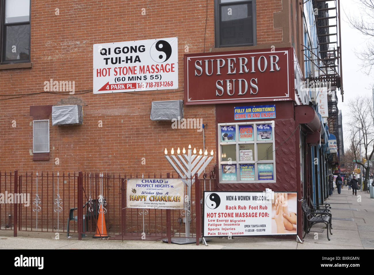 Eclectic group of signs on a building on 5th Avenue in Brooklyn, New York. Stock Photo