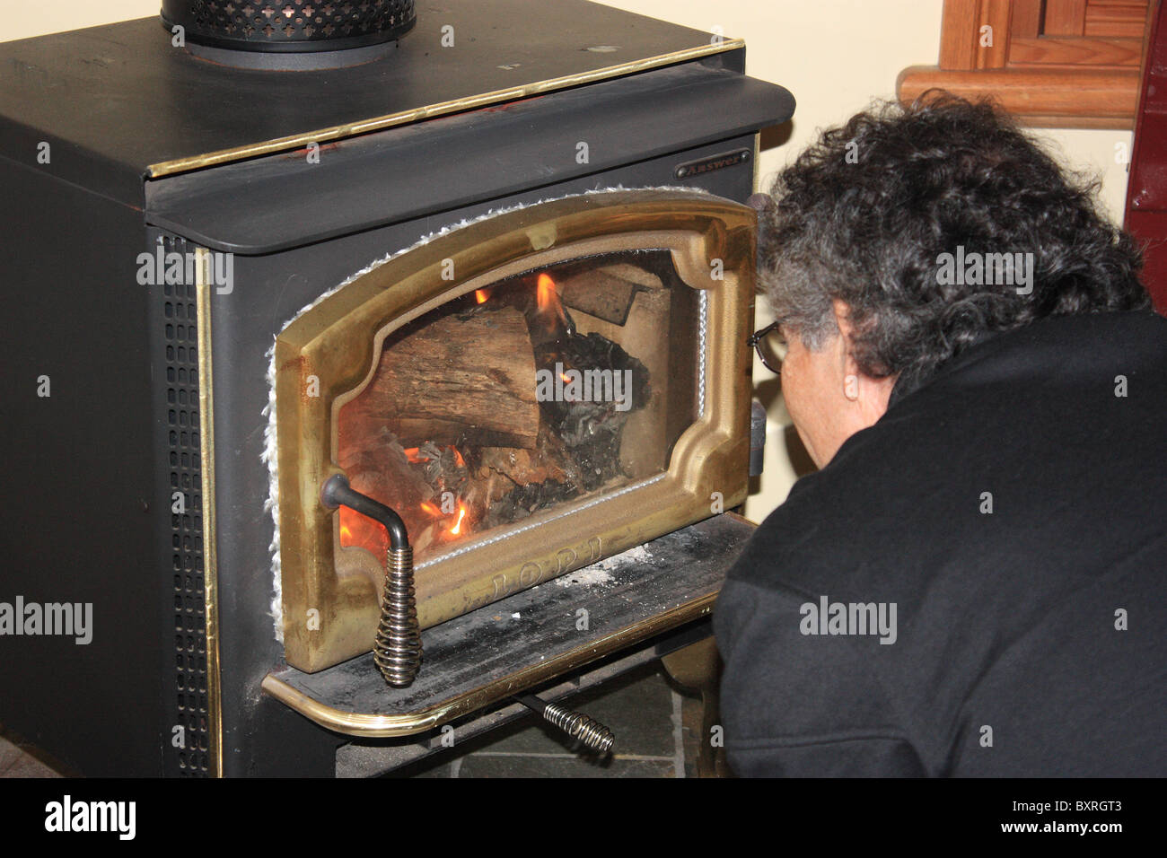 Man stoking a fire hires stock photography and images Alamy