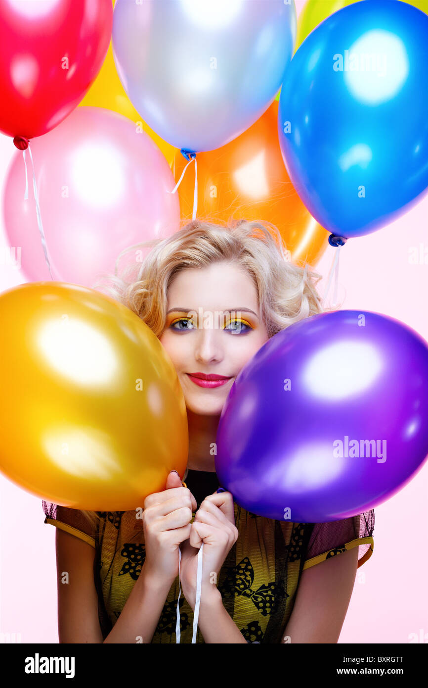 portrait of beautiful blonde girl with balloons celebrating birthday