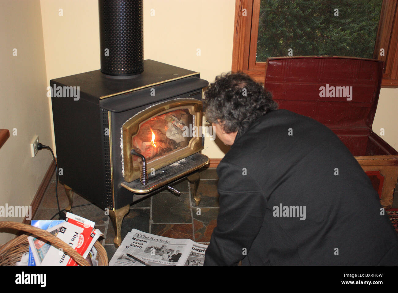 Man stoking a fire hires stock photography and images Alamy