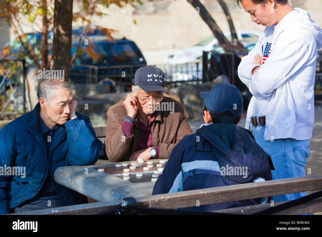 Chinese Americans playing Xiang qi, or Chinese chess in Columbus Park, Chinatown, New York City Stock Photo