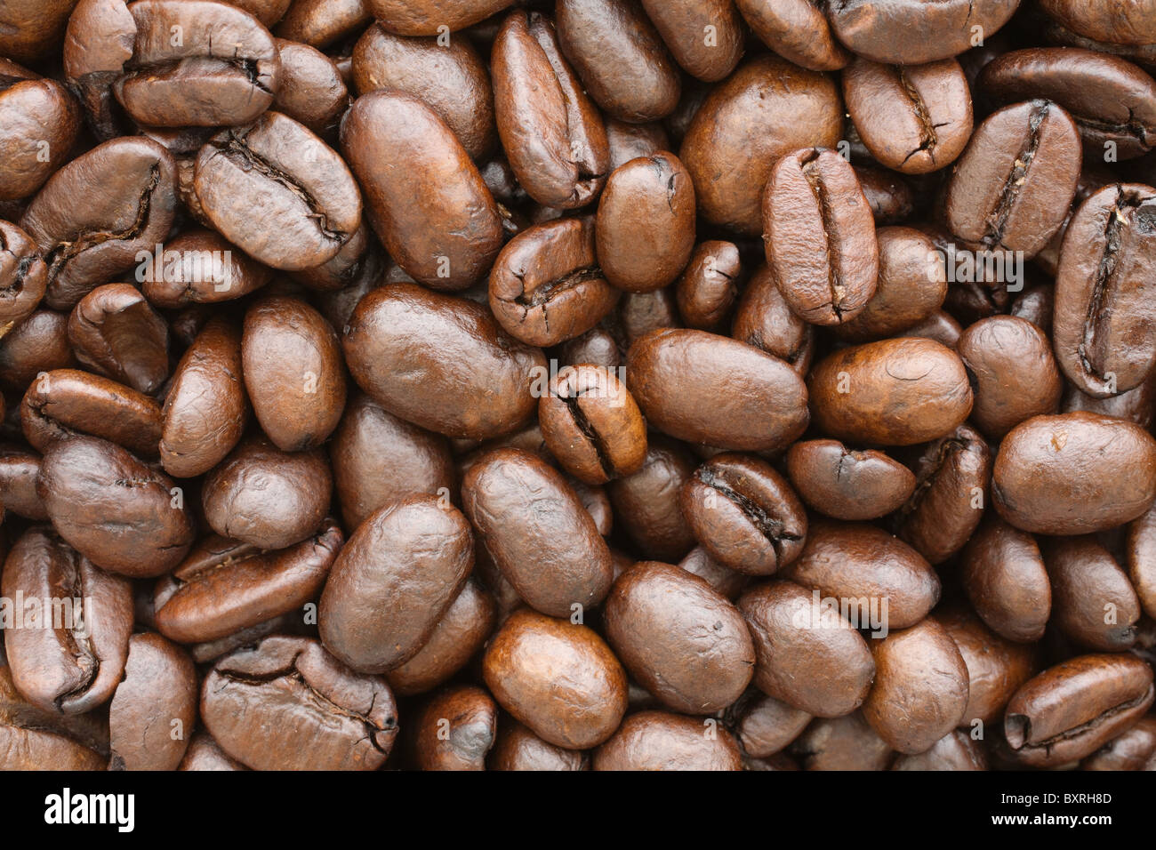 pile of brown roasted coffee beans close-up Stock Photo - Alamy
