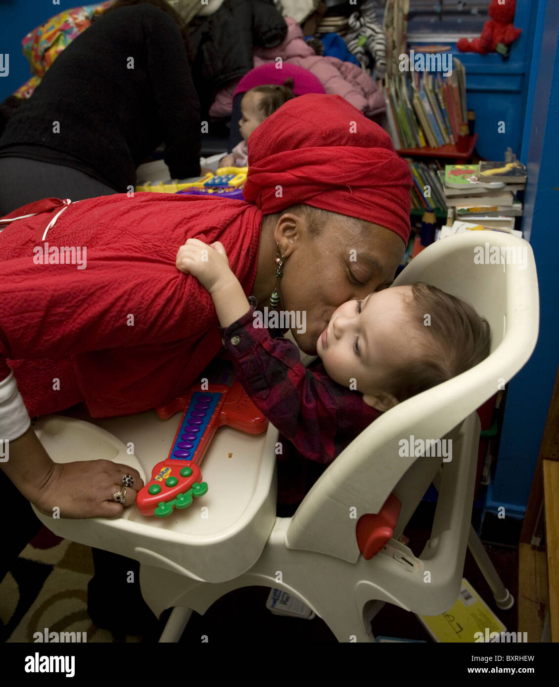 Babies and young children in all day care need love and affection. Childcare preschool in Brooklyn, NY. Stock Photo