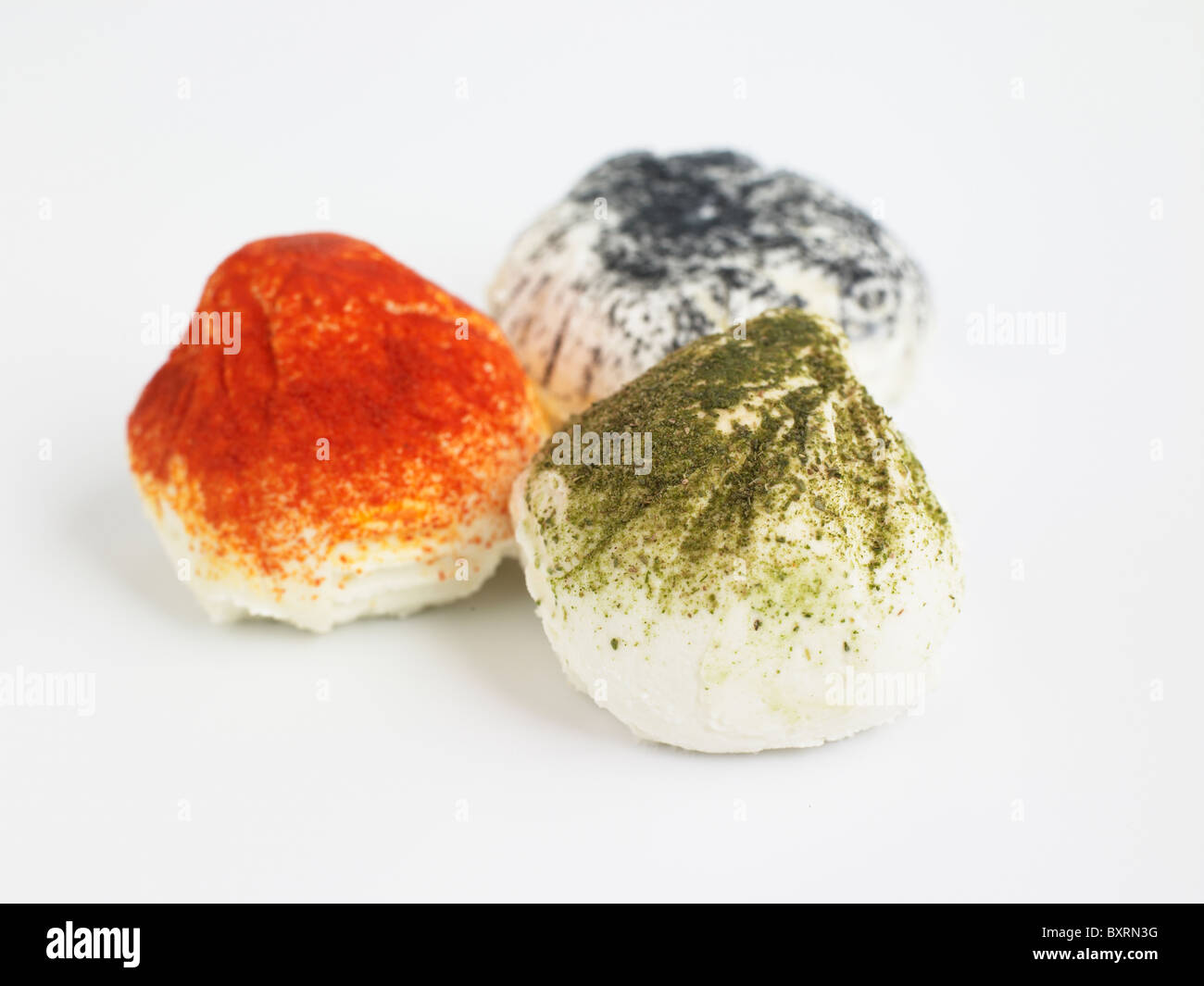 French Figuette goat's cheeses on white background, ash, paprika and tarragon, close-up Stock Photo