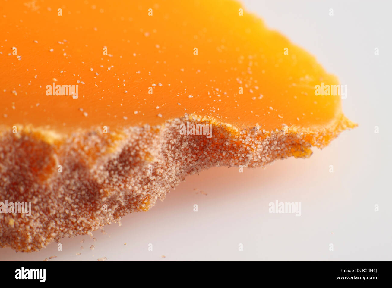Slice of French Mimolette cow's milk cheese, close-up Stock Photo
