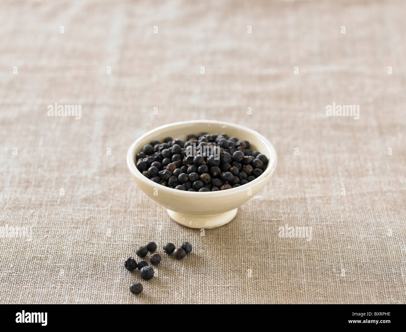 Bowl of juniper berries Stock Photo