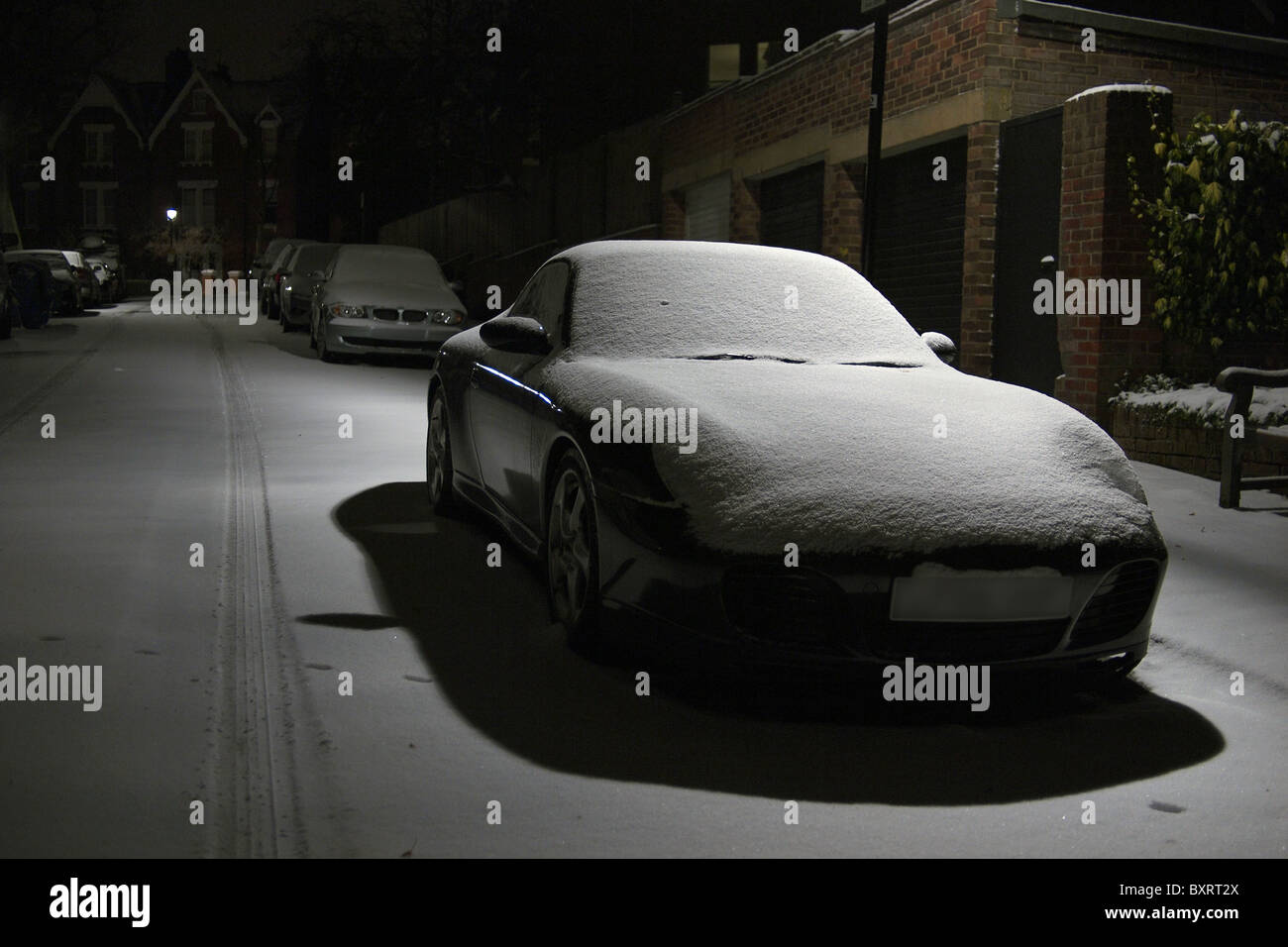 Winter snow as a blanket on a Porsche Carrera 911 in London England UK Stock Photo