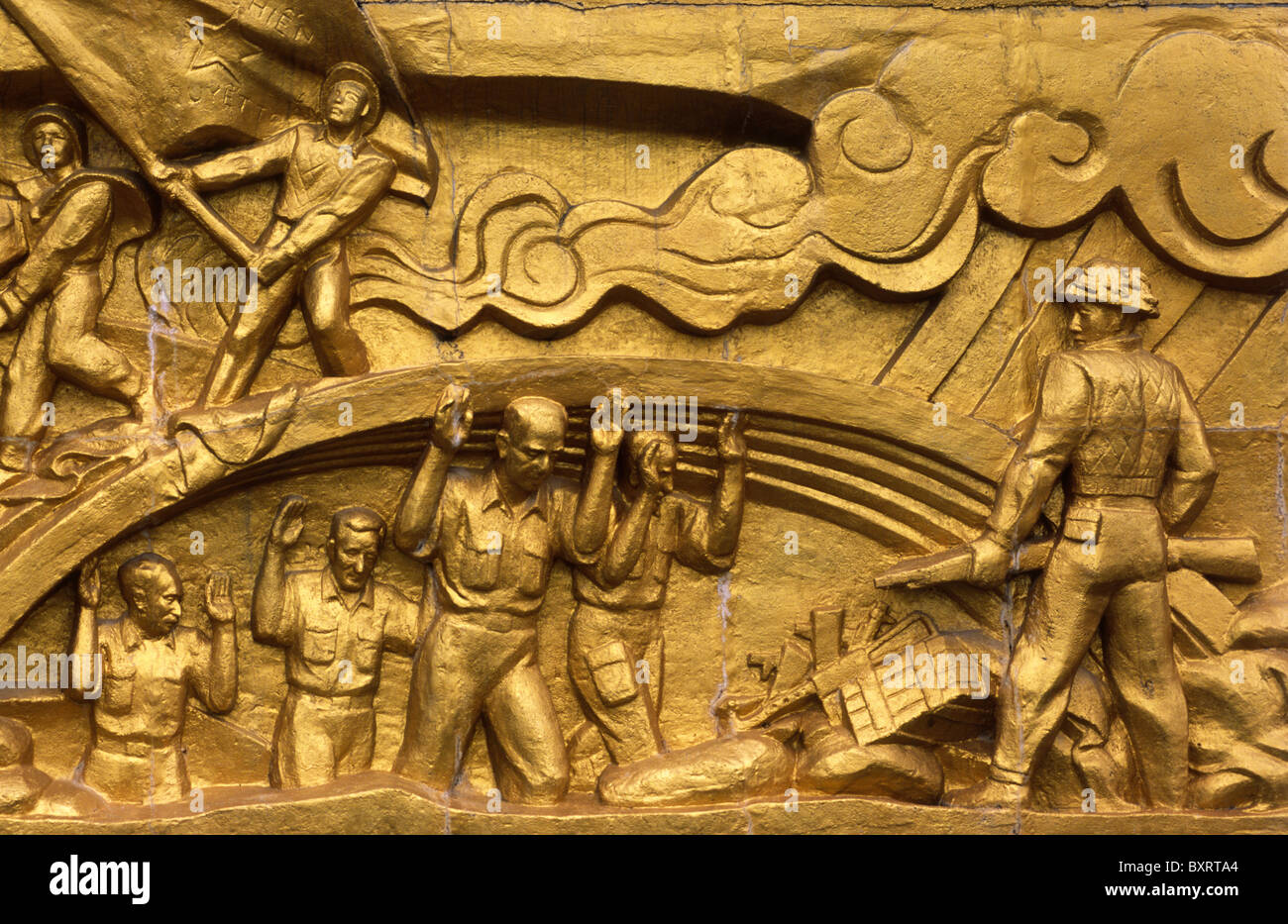 Reliefs with  the scenes from the Battle of Dien Bien Phu at war cemetery; French commanders surrender to Viet Minh soldiers. Stock Photo