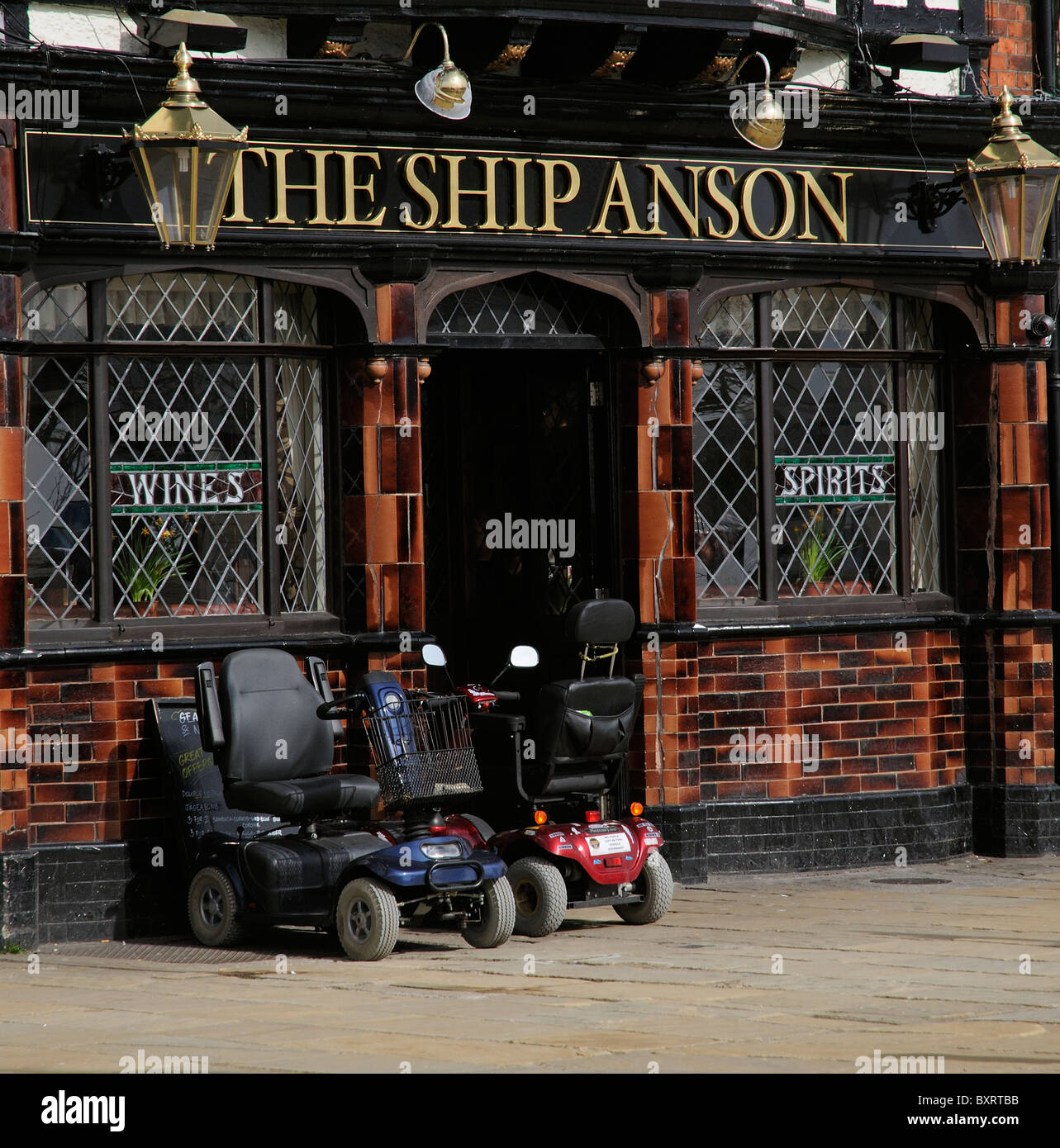 Mobility scooters parked outside an English pub Stock Photo
