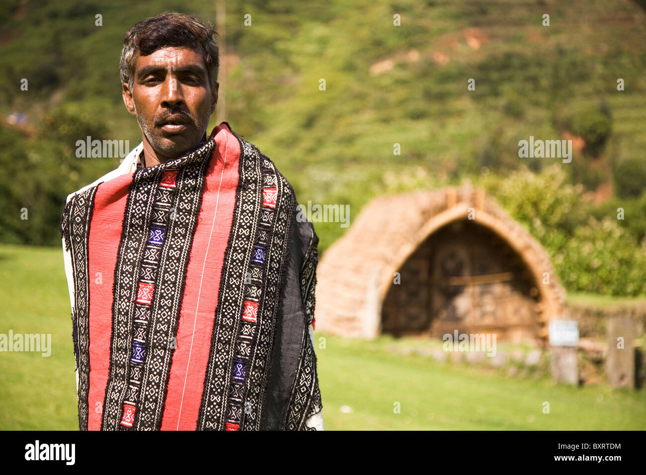 A man from the Toda tribe stands in front of the temple within the Ooty Botanical Gardens Mund (village) in Tamil Nadu, India. Stock Photo