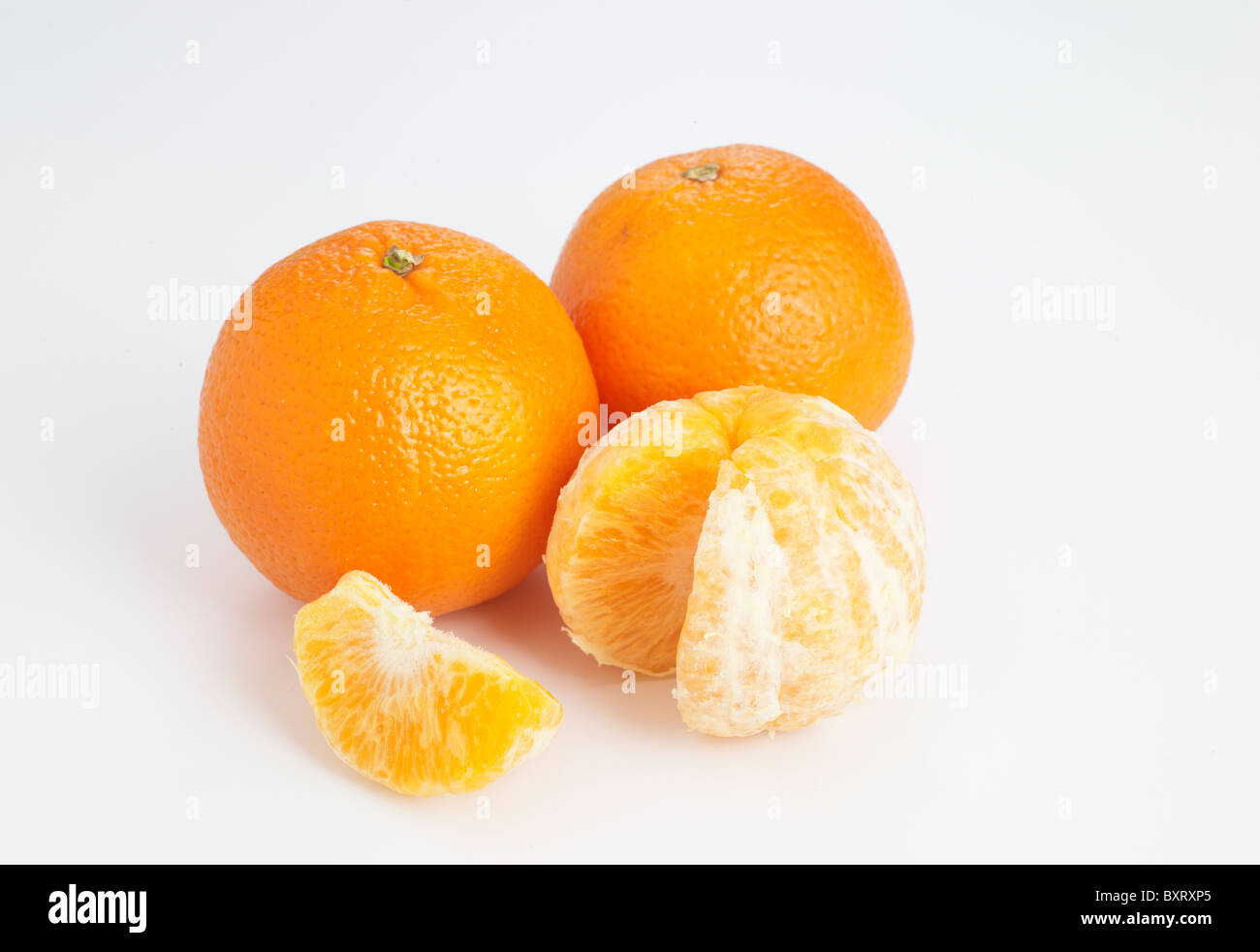 Clementine whole and peeled on white background Stock Photo Alamy